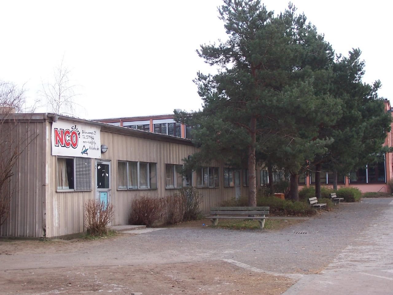 KAHS Annex 12-04 — *The sign says "NCO Club Delaware Str. 21 Tel. 9714866 nco-cl